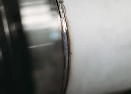 Close-up of a stainless steel tube showing a welded seam.