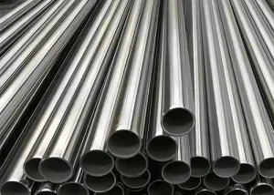 A stack of polished alloy pipes manufactured to ASTM-B622 standards, neatly arranged in rows.